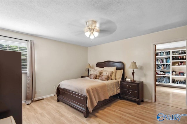 6304 Cedar Point Dr, Huntsville, AL 35810 - bedroom featuring light wood finished floors, a textured ceiling, baseboards, and a ceiling fan
