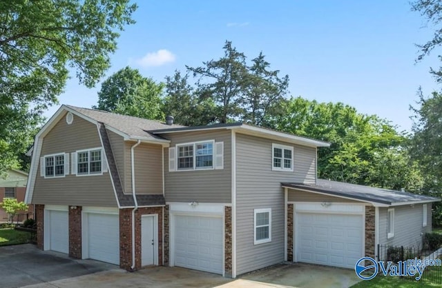 6304 Cedar Point Dr, Huntsville, AL 35810 - view of home's exterior featuring a garage, concrete driveway, and brick siding
