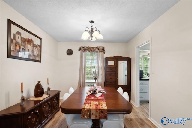 6304 Cedar Point Dr, Huntsville, AL 35810 - dining space with light wood finished floors, a chandelier, and baseboards