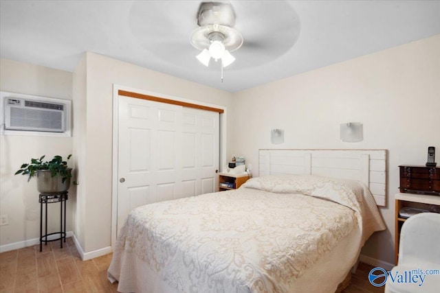 6304 Cedar Point Dr, Huntsville, AL 35810 - bedroom featuring an AC wall unit, a closet, baseboards, light wood-style flooring, and a ceiling fan