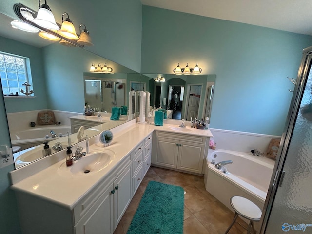 bathroom with double vanity, a stall shower, and a sink