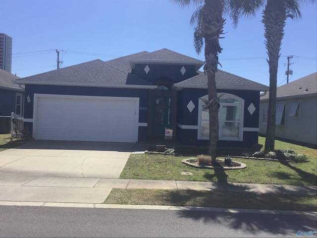 single story home with driveway, a shingled roof, a garage, and a front yard