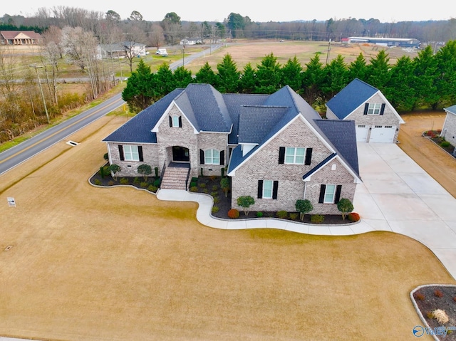 view of front facade featuring a garage, concrete driveway, and roof with shingles