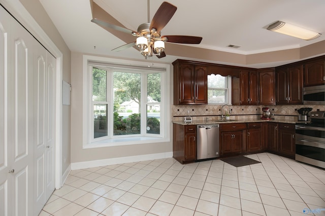 kitchen with dark brown cabinets, sink, decorative backsplash, and appliances with stainless steel finishes