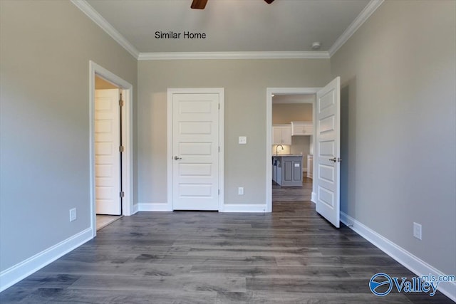 unfurnished bedroom featuring ceiling fan, sink, dark wood-type flooring, and ornamental molding