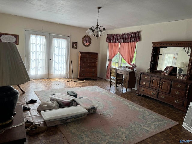 bedroom with a chandelier and french doors