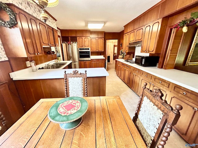 kitchen with sink, stainless steel appliances, and light tile patterned floors