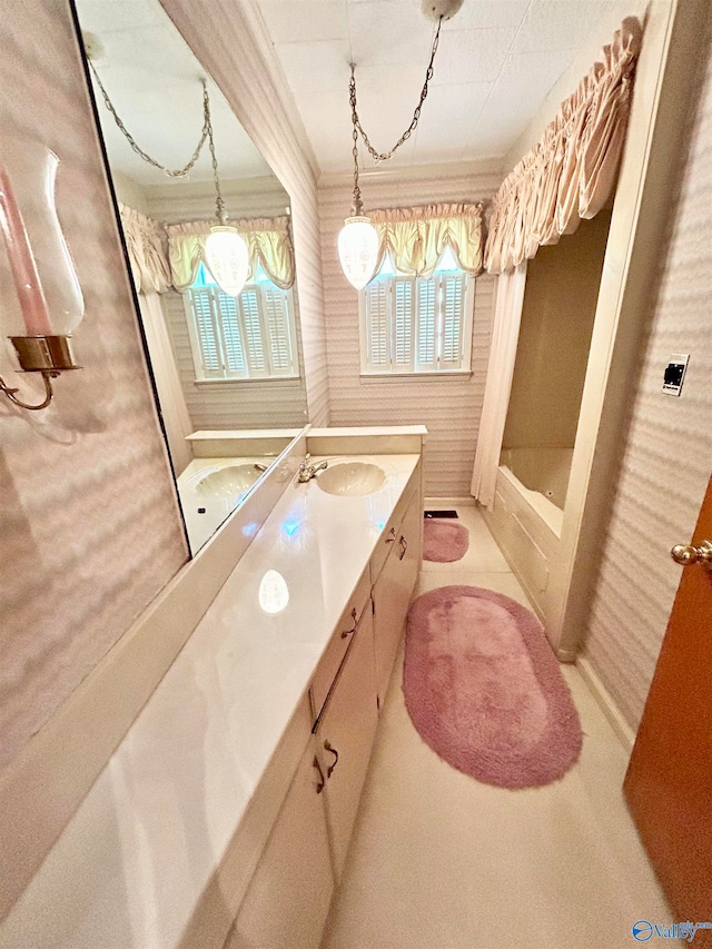 bathroom featuring tile patterned flooring, a healthy amount of sunlight, and vanity