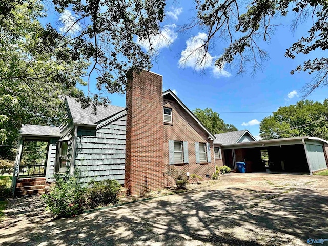 view of side of home featuring a carport