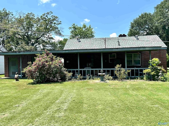 rear view of house with a yard