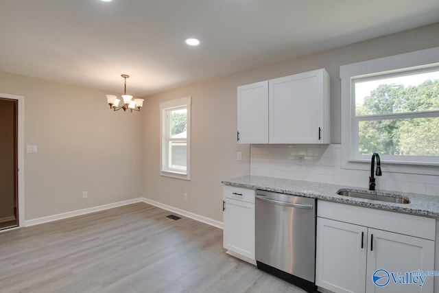 kitchen with light hardwood / wood-style flooring, tasteful backsplash, dishwasher, sink, and an inviting chandelier