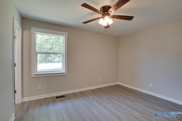 spare room featuring ceiling fan and light hardwood / wood-style floors