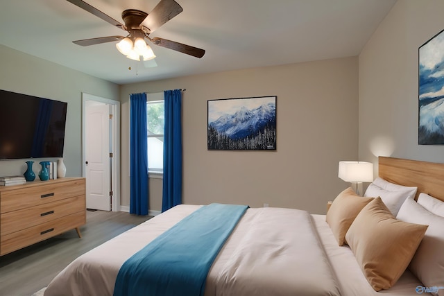 bedroom with ceiling fan and light hardwood / wood-style flooring