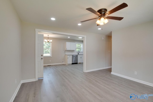 interior space with sink, light hardwood / wood-style flooring, and ceiling fan with notable chandelier