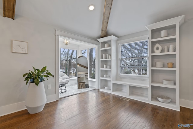 interior space featuring dark wood-type flooring and beamed ceiling