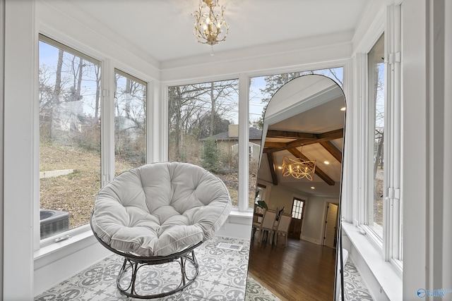 sunroom with a chandelier and lofted ceiling with beams