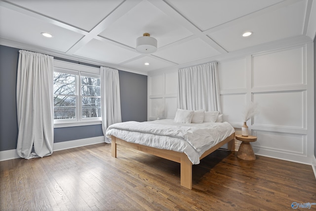 bedroom with coffered ceiling and hardwood / wood-style floors