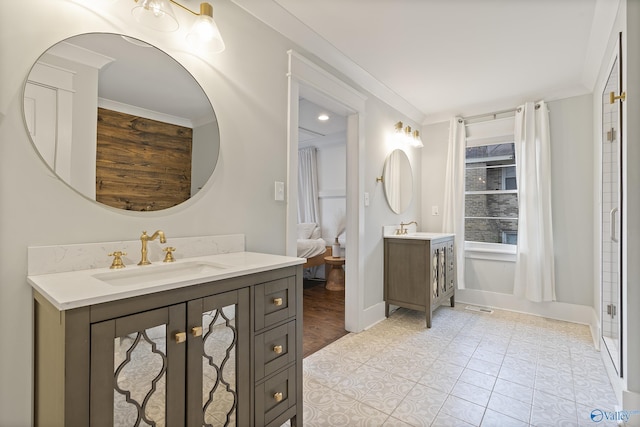 bathroom with crown molding, vanity, tile patterned flooring, and walk in shower