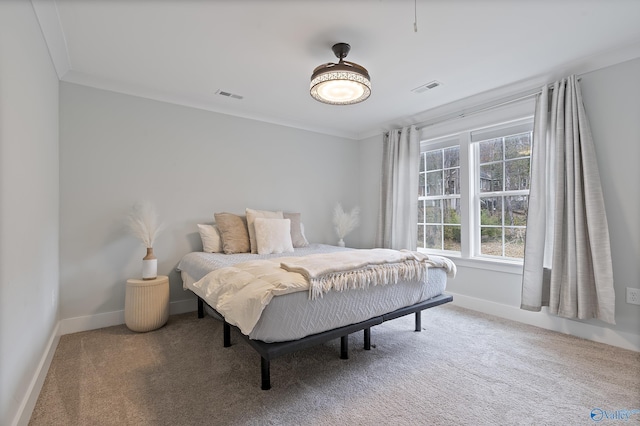 bedroom with ornamental molding and carpet