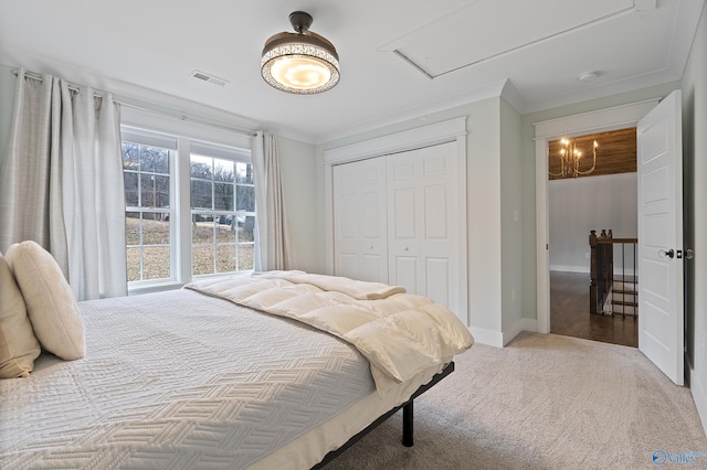 carpeted bedroom with ornamental molding and a closet