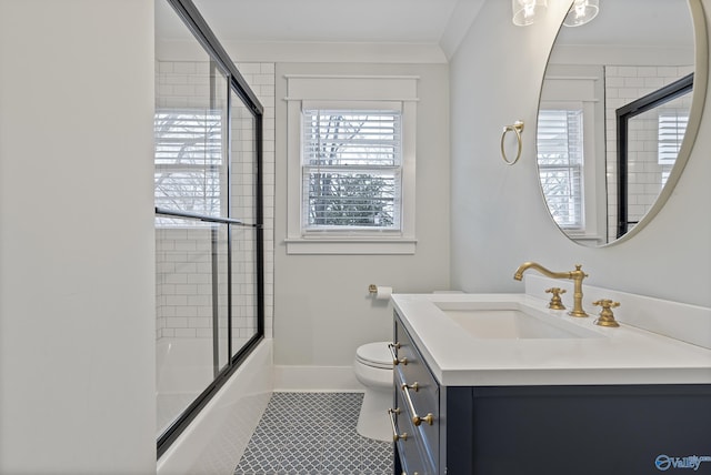 full bathroom with toilet, combined bath / shower with glass door, ornamental molding, vanity, and tile patterned flooring