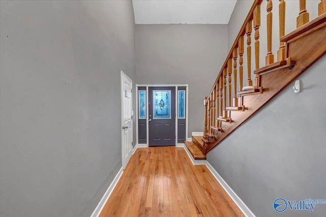 entryway featuring a high ceiling and light wood-type flooring