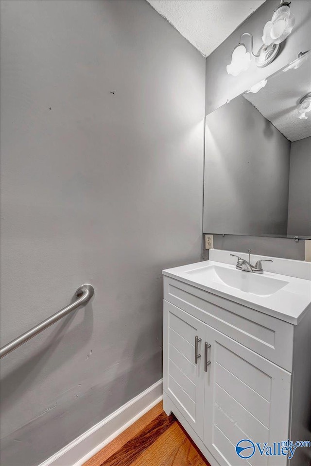 bathroom featuring vanity, a textured ceiling, and wood-type flooring