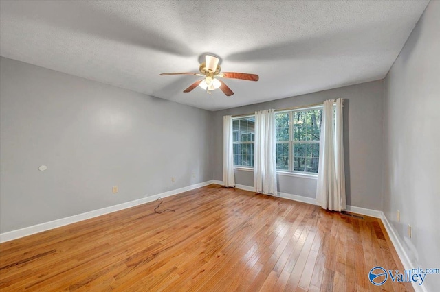 unfurnished room featuring light hardwood / wood-style flooring, a textured ceiling, and ceiling fan