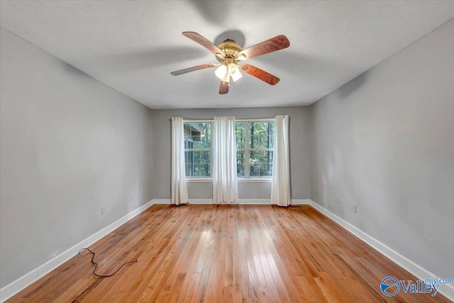 empty room with light hardwood / wood-style floors, a textured ceiling, and ceiling fan