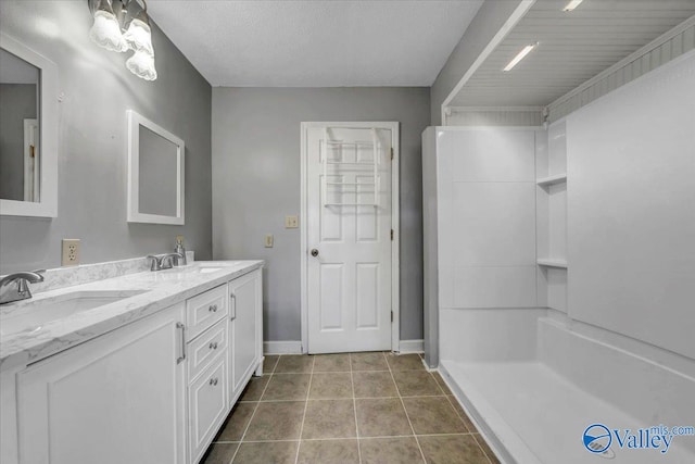 bathroom featuring vanity, walk in shower, and tile patterned flooring