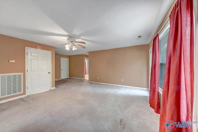 unfurnished room featuring ceiling fan and light carpet