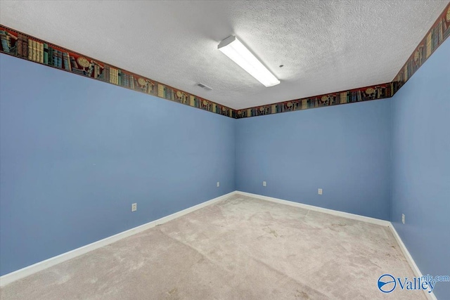 spare room with carpet and a textured ceiling