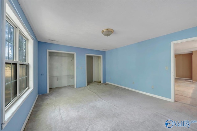 unfurnished bedroom featuring a closet and carpet