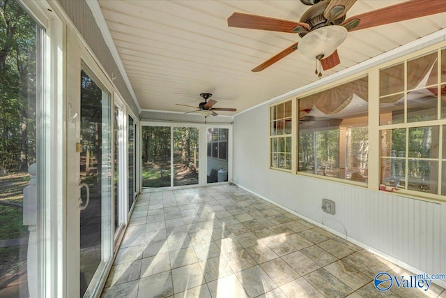 unfurnished sunroom with ceiling fan