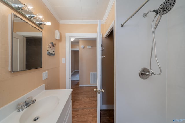 2116 Virginia Blvd NW, Huntsville, AL 35811 - full bathroom featuring crown molding, a shower, vanity, and wood finished floors