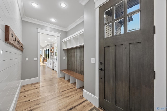 mudroom with light hardwood / wood-style floors and crown molding