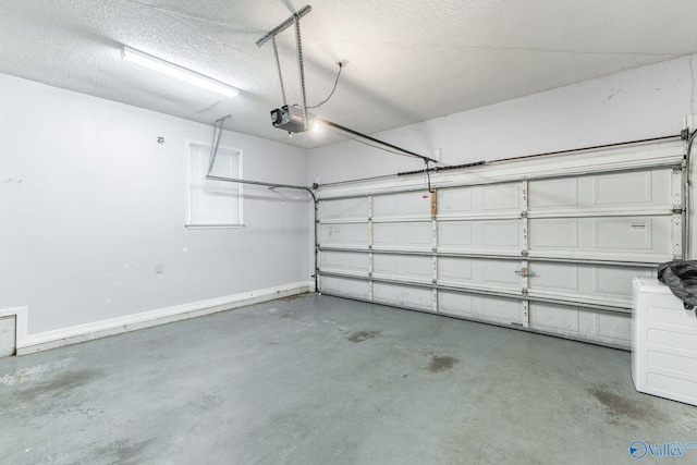 garage featuring a garage door opener and baseboards