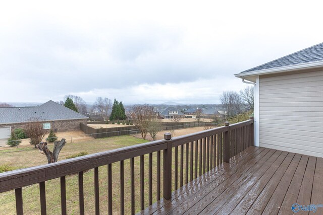 wooden deck with a residential view, a yard, and fence