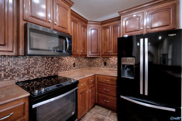 kitchen featuring light tile patterned floors, tasteful backsplash, light countertops, electric range, and black refrigerator with ice dispenser