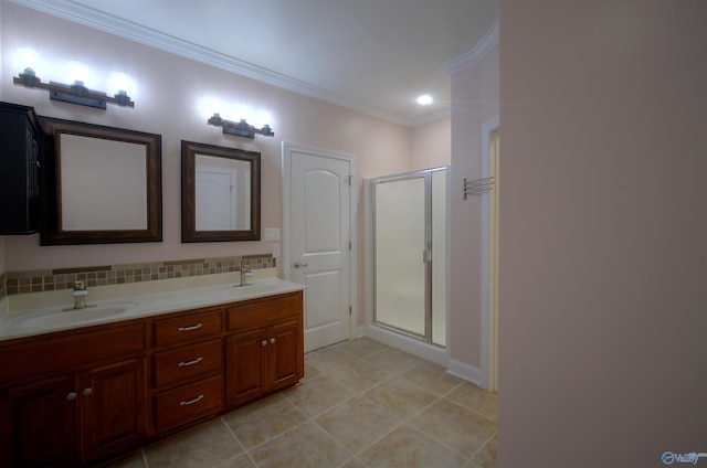 bathroom with a shower stall, ornamental molding, tile patterned flooring, and a sink