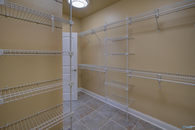 walk in closet with tile patterned floors
