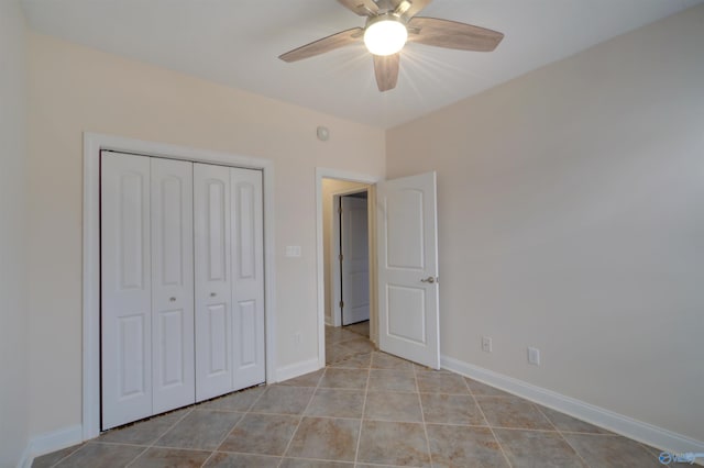 unfurnished bedroom featuring light tile patterned floors, a closet, ceiling fan, and baseboards