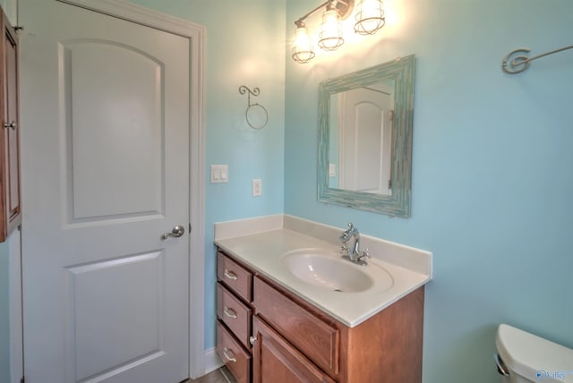 bathroom with toilet and vanity