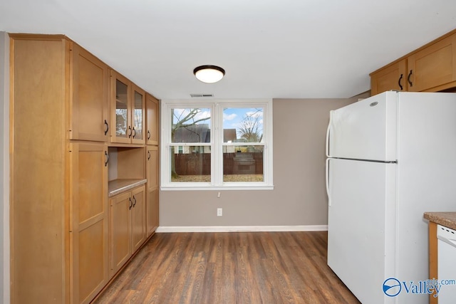 kitchen with white appliances and dark wood-type flooring