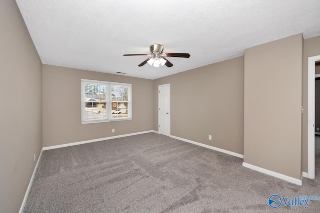 empty room featuring ceiling fan, a textured ceiling, and carpet