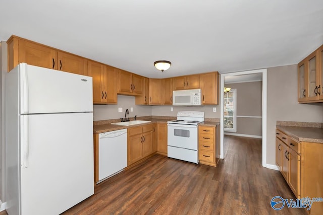 kitchen with white appliances, dark hardwood / wood-style flooring, and sink