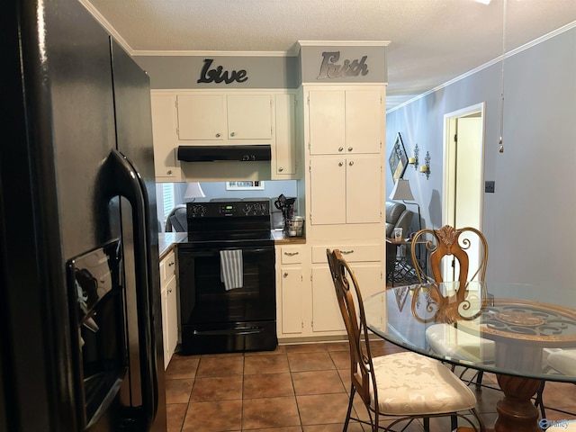 kitchen featuring white cabinets, dark tile patterned flooring, ornamental molding, under cabinet range hood, and black appliances