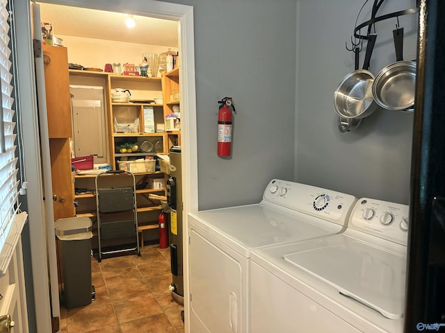 washroom with washer and dryer, laundry area, and tile patterned floors