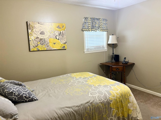 carpeted bedroom featuring baseboards