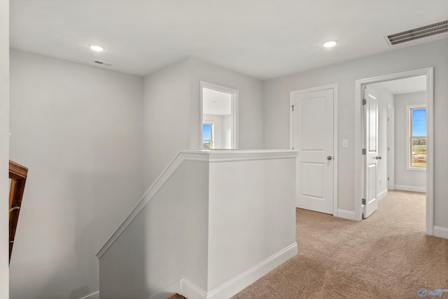 corridor with light colored carpet